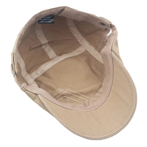 Inside view of khaki cotton flat cap showing reinforced seams and adjustable metal buckle