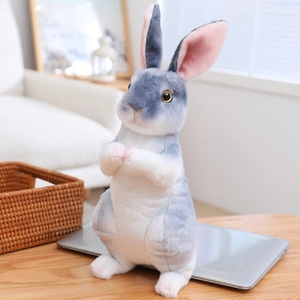 Detailed view of a grey and white plush rabbit doll with realistic pink inner ears