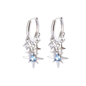 Silver hoop earrings with blue zircon star charms and star tassels on white background