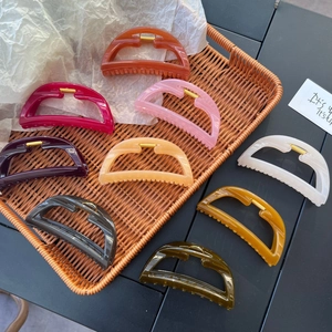 Set of 9 colorful hollow large hair claws in a woven basket for thick hair accessory