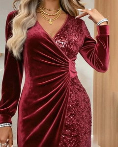 Detail of burgundy V-neck velvet dress featuring elegant sequins and waist pleats