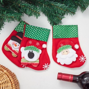 Three sequined Christmas stockings set with Santa, polar bear and snowman for decor
