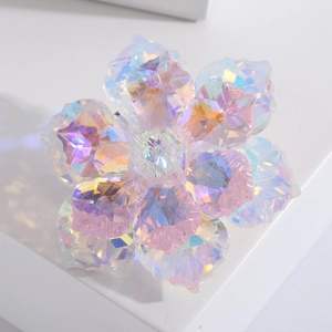 Luxurious crystal flower brooch with iridescent AB coating on a white pedestal