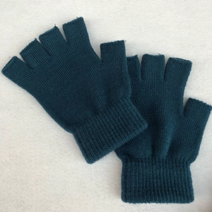 Detail of dark cyan knitted half-finger gloves with elastic ribbed cuffs for warmth