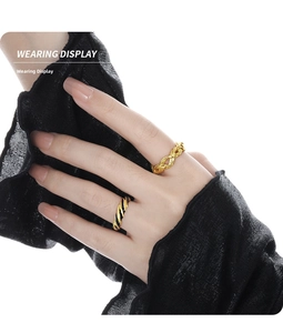 Close-up of twisted rope and interlocked knot gold rings on a model finger