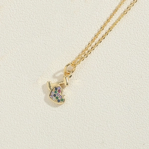 Detail of 14K gold plated necklace featuring I-shaped charm and colorful zircon heart pendant
