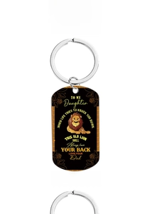 Detail of stainless steel dog tag keychain with lion design and message for daughter