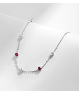 Close-up of S925 sterling silver bracelet featuring red gemstones and clear zircons