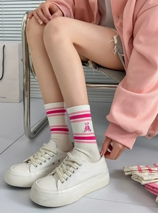 Close-up of white cotton crew sock with pink stripes and cute bear embroidery detail