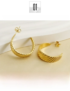 Detailed close-up of 18K gold-plated titanium steel hoop earrings with textured patterns
