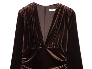 Close-up of deep brown velvet midi dress featuring ruched details and a V-neck design
