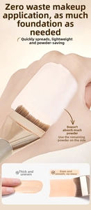 Flat foundation brush applying liquid base smoothly on skin for seamless finish