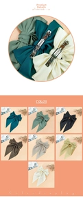 Detail of large satin bow hair clip with metal spring fastener and 7 color options