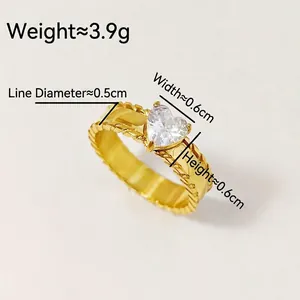 Luxury gold titanium steel ring with a heart-shaped zircon and twisted rope textured band