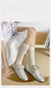 Detail of cream lace hollow-out calf socks showing delicate mesh cotton texture