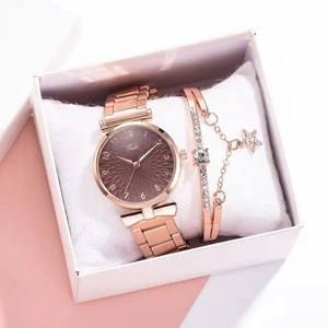 Detail of rose gold Tadi watch with star bracelet set in a premium white gift box