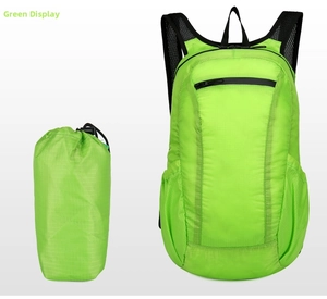 Macro detail of foldable green waterproof backpack showing lightweight texture and storage bag
