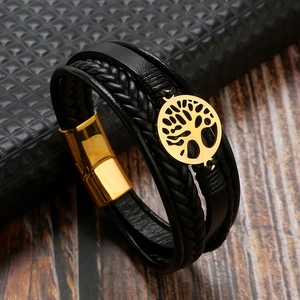 Macro detail of black leather tree of life bracelet with a golden magnetic clasp