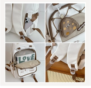 Detail views of white nylon backpack with side pockets and mini mushroom coin purse accessory