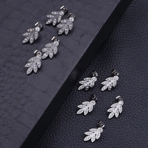 Minimalist leaf-shaped stainless steel stud earrings with crystal rhinestones on black base
