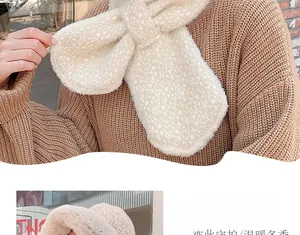 Detailed view of plush polka dot winter scarf with a convenient pull-through cross buckle