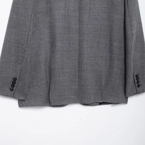 Back view of gray vintage oversized blazer showing split hem and buttoned sleeve cuffs