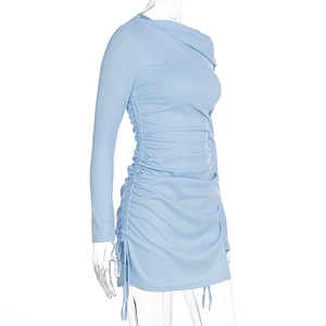Detail of light blue ribbed knit dress featuring side drawstring ruching and slim fit