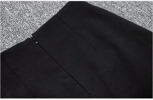 Detailed view of black high waist skirt featuring a hidden zipper and woven fabric texture