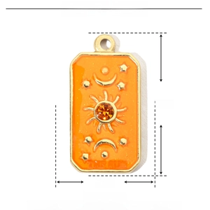 Detail of sun-themed tarot pendant with orange enamel, rhinestones and size dimensions