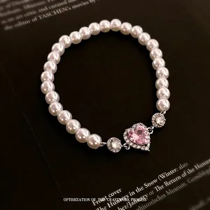 Pink heart zircon pearl elastic bracelet with silver metal setting on black book