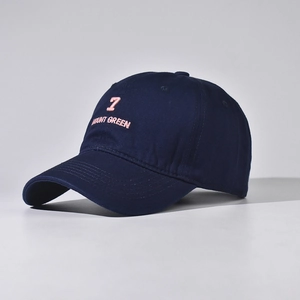 Detail of navy cotton baseball cap featuring pink number 7 and Mount Green embroidery