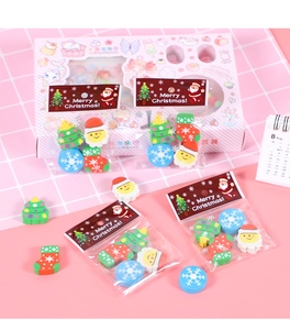 Detailed view of Christmas themed erasers in festive tree and Santa Claus shapes