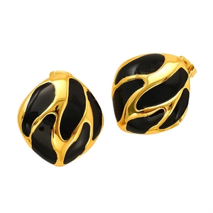 Elegant gold metal earrings with black enamel wave texture on a clean white background