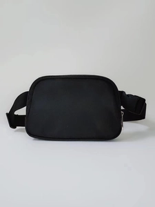 Detail of waterproof black nylon waist bag featuring zip closure and adjustable buckle strap