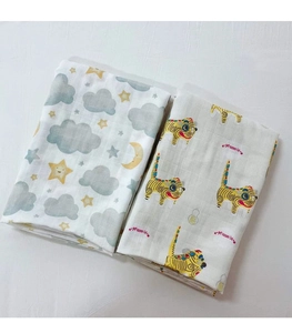 Detailed texture of folded muslin bamboo cotton baby swaddle with moon and star patterns