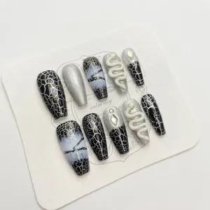 Handmade press-on nails set in black and silver with 3D snake and spider web designs