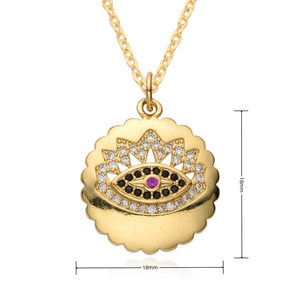 Macro detail of 18mm gold devil's eye pendant with pink stone and zircon micro-paving