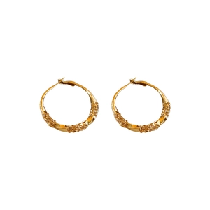 Elegant gold twisted hoop earrings with shimmering crystals on a minimalist background