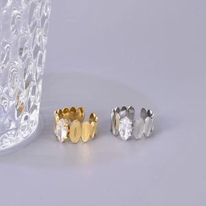 Detail of gold and silver chain link rings featuring marquise-cut zircon stones