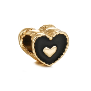 Macro shot of black enamel heart charm bead with gold plating for DIY bracelets