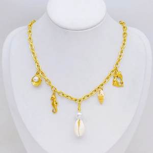 Gold sea theme necklace with seahorse, shell and dolphin charms on a neck model