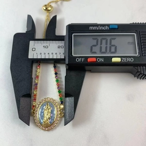 Close-up measuring the 20.6mm width of the colorful zircon Virgin Mary charm