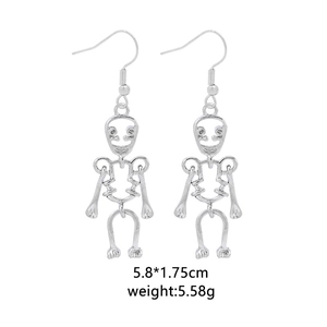 Detail view of silver skeleton drop earrings with dimensions 5.8x1.75cm and 5.58g weight