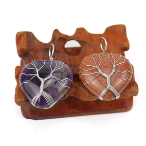 Silver handmade wire-wrapped tree of life pendant with purple and reddish crystal hearts