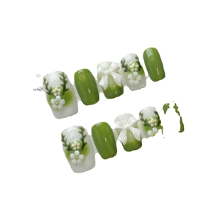 Handmade green and cream gradient press-on nails with 3D bows and floral patterns