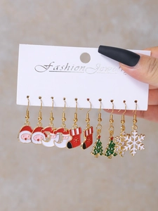 Detailed close-up of Christmas earring set with Santa, snowflake, and tree charms