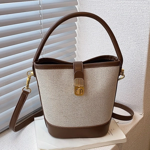 Retro contrast color bucket bag with canvas stitching brown leather and gold hardware