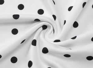 Detailed macro view of high-density polka dot fabric texture for summer wrap dress