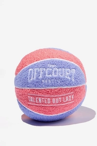 Detail of plush basketball pillow featuring pink and purple patches with white embroidery
