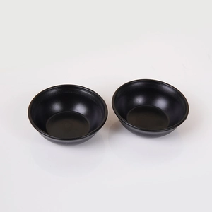 Pair of minimalist matte black miniature sauce bowls in a durable ceramic style design